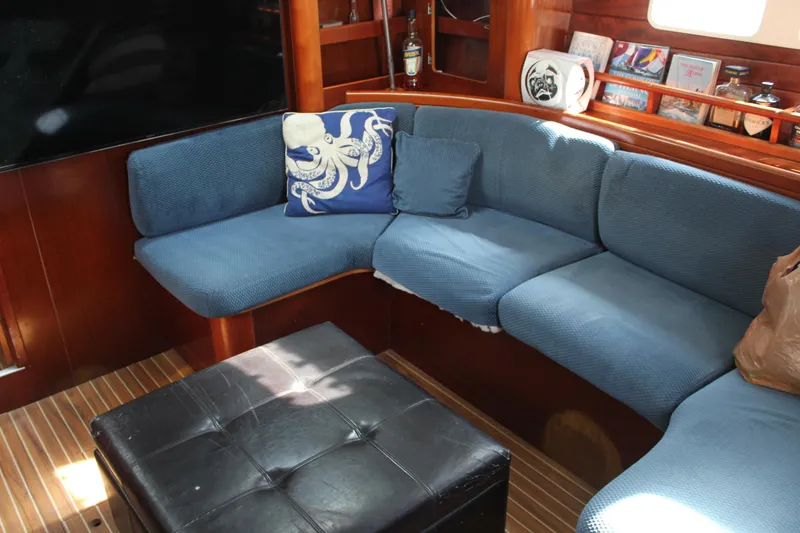 Slide: The Image of Interior of 1997 Beneteau Oceanis 461 yacht with blue seating and nautical decor. - 25