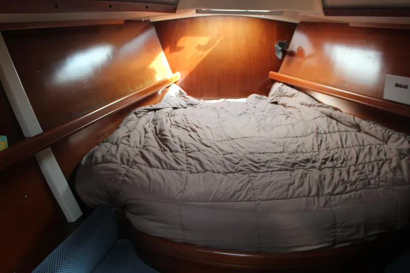 Slide: The Image of Cozy cabin interior of 1997 Beneteau Oceanis 461 sailboat with wooden finish and bedding. - 31