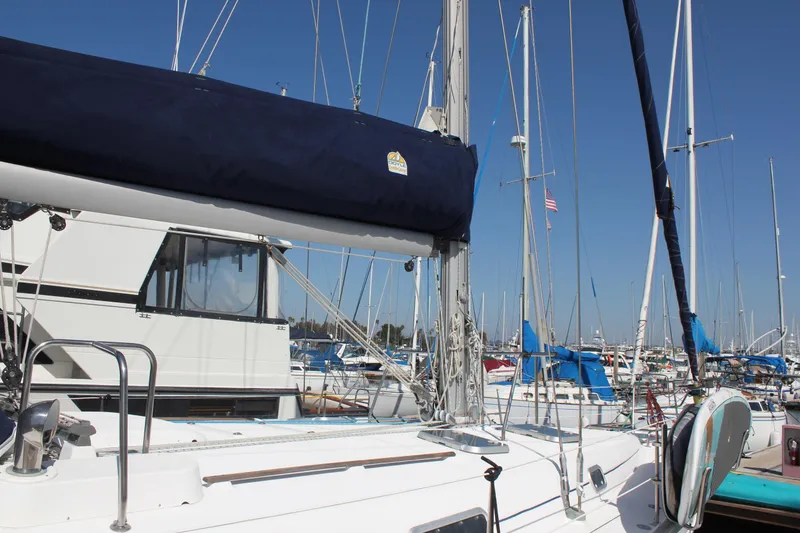 Slide: The Image of 1997 Beneteau Oceanis 461 sailboat docked in a marina under clear blue skies. - 5