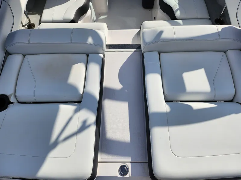 Slide: The Image of 2021 Regal LS2 boat interior with white cushioned seating. - 10