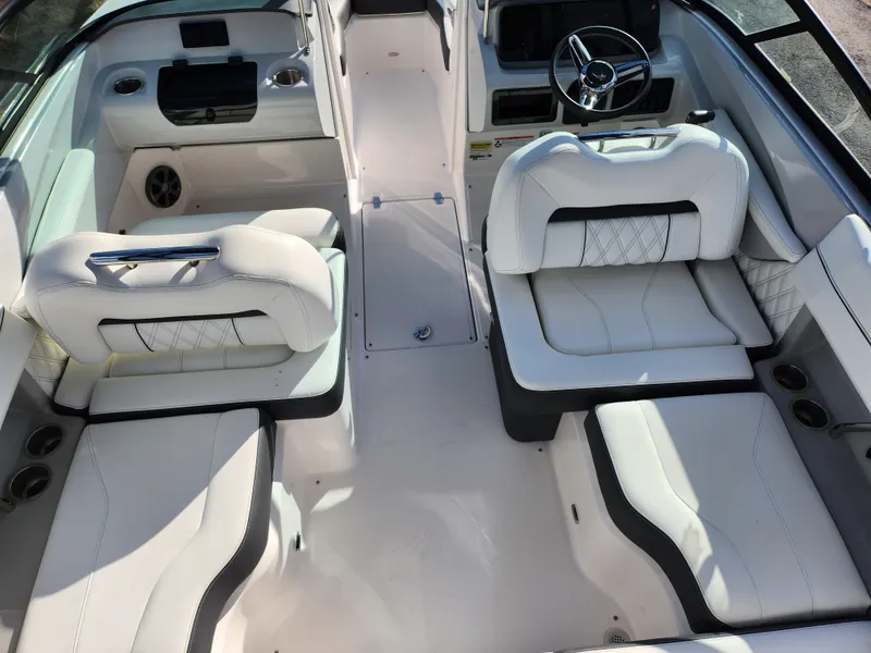 Slide: The Image of 2021 Regal LS2 boat interior with white seating and modern dashboard. - 12
