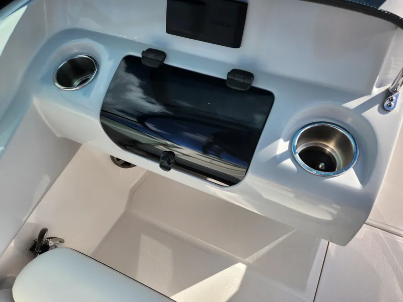 Slide: The Image of 2021 Regal LS2 boat dashboard with cup holders and storage compartment. - 14