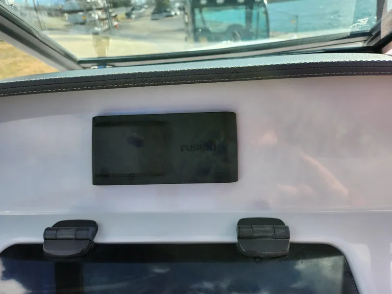 Slide: The Image of 2021 Regal LS2 boat dashboard with Fusion audio system display. - 16
