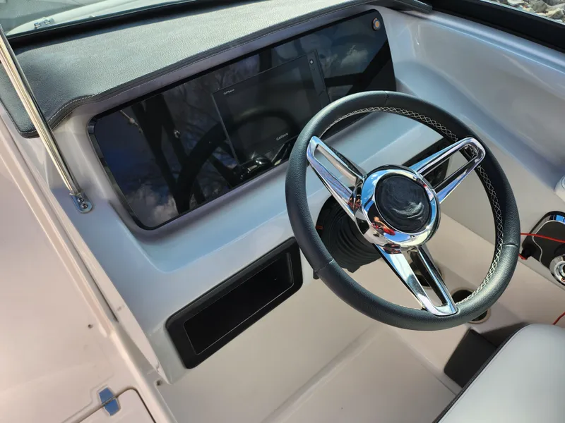 Slide: The Image of 2021 Regal LS2 boat dashboard with steering wheel and control panel. - 19