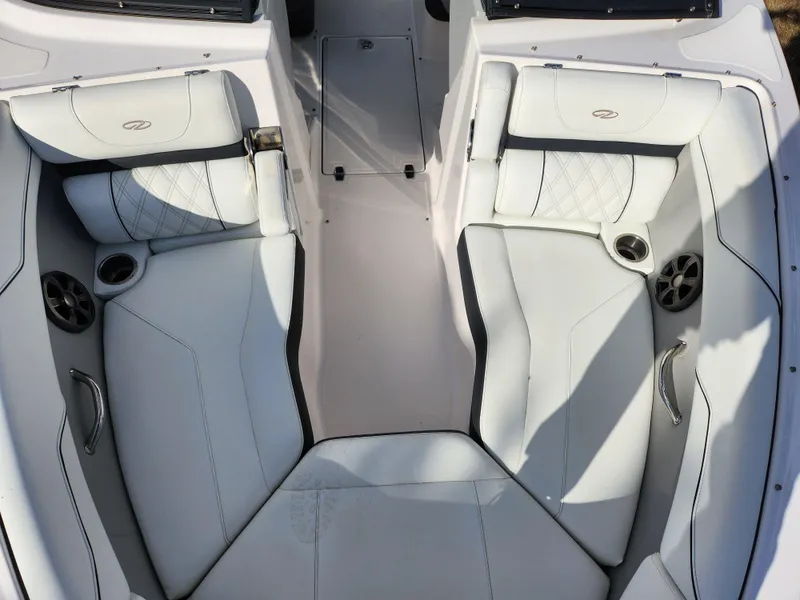 Slide: The Image of 2021 Regal LS2 boat interior with white leather seating and cup holders. - 22