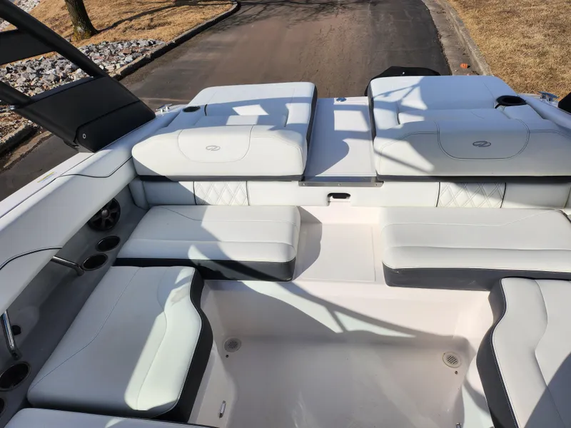 Slide: The Image of 2021 Regal LS2 boat interior with white seating and cup holders. - 25