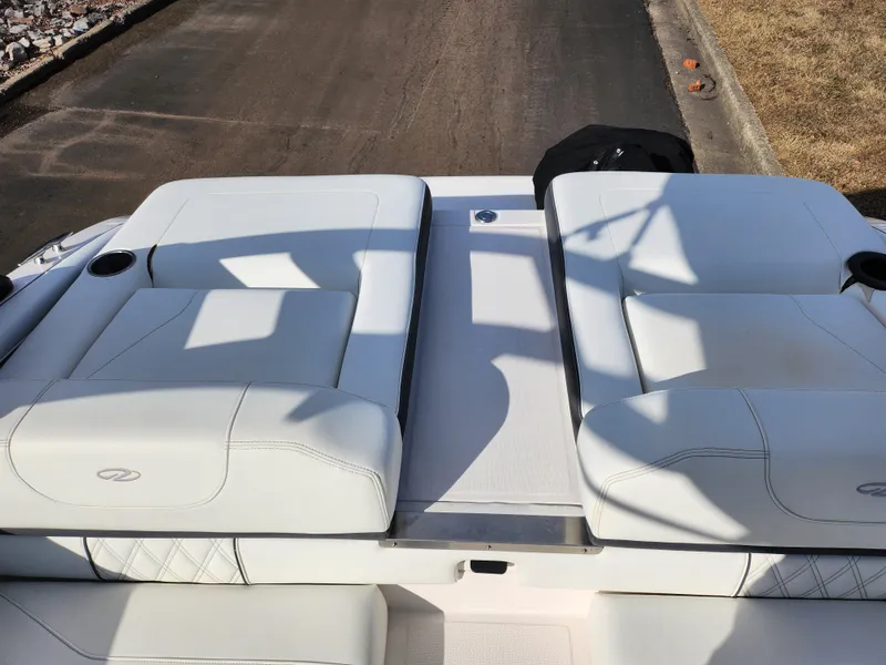 Slide: The Image of 2021 Regal LS2 boat with white cushioned seating on deck. - 26