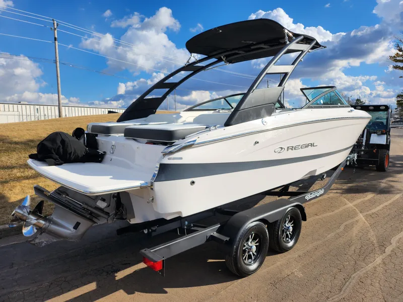 Slide: The Image of 2021 Regal LS2 boat on trailer under blue sky with clouds. - 3