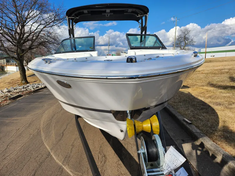 Slide: The Image of 2021 Regal LS2 boat on trailer, parked outdoors under a clear blue sky. - 6