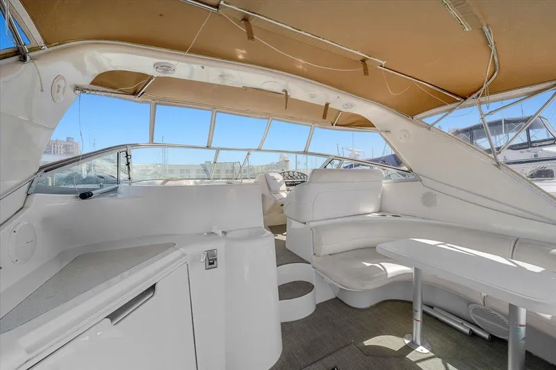Slide: The Image of 1999 Cruisers Yachts 3870 Esprit interior with white seating and canopy. - 11