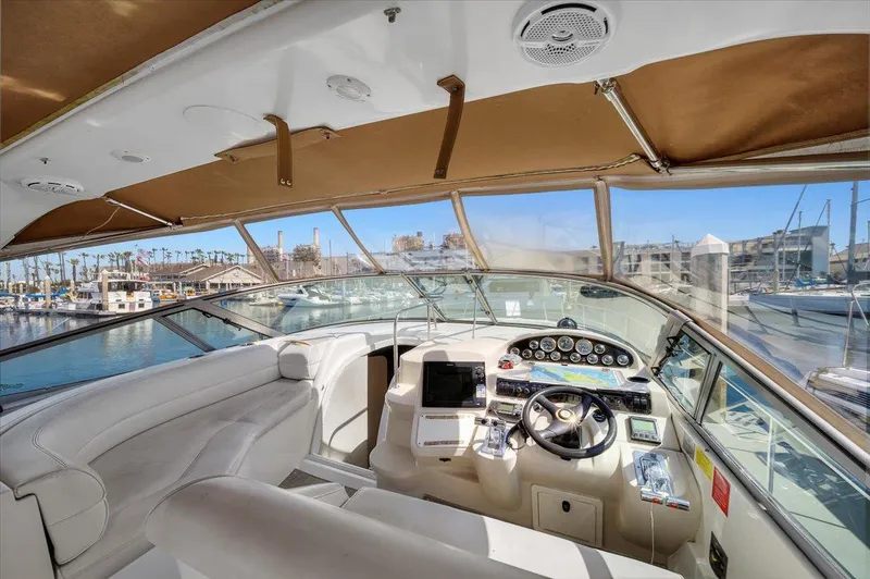 Slide: The Image of 1999 Cruisers Yachts 3870 Esprit cockpit with luxurious seating and modern controls. - 15