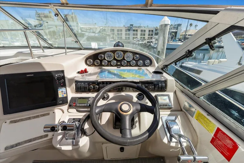Slide: The Image of 1999 Cruisers Yachts 3870 Esprit helm with steering wheel, gauges, and navigation equipment. - 17