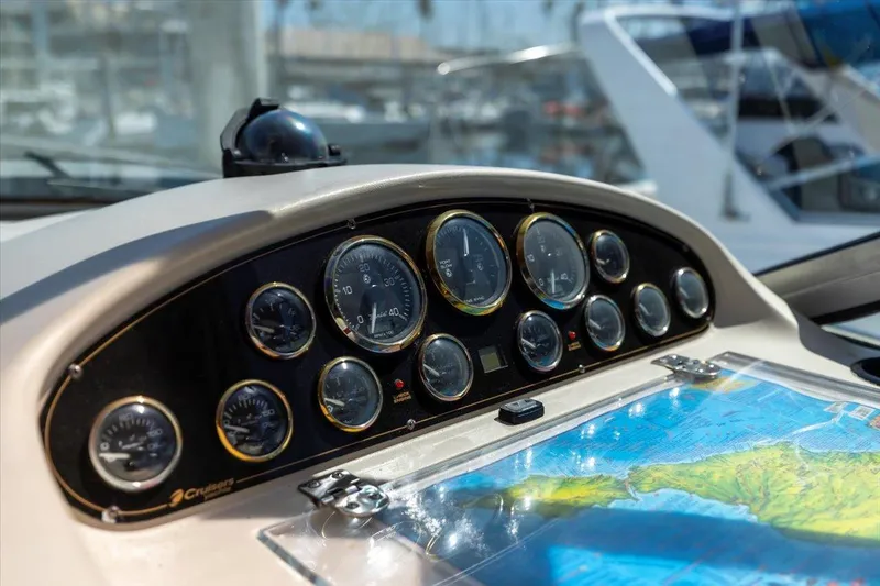 Slide: The Image of Dashboard of 1999 Cruisers Yachts 3870 Esprit with gauges and nautical map. - 18
