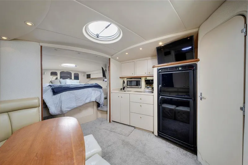 Slide: The Image of Interior of 1999 Cruisers Yachts 3870 Esprit with kitchen and sleeping area. - 19