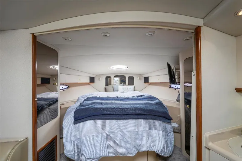 Slide: The Image of 1999 Cruisers Yachts 3870 Esprit cabin interior with bed, mirrors, and cozy lighting. - 22
