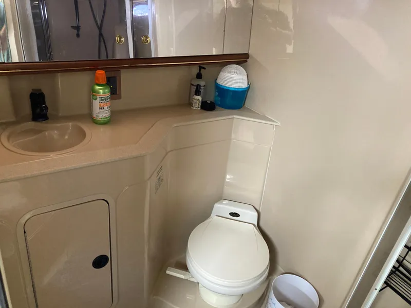 Slide: The Image of 1999 Cruisers Yachts 3870 Esprit bathroom with sink, toilet, and toiletries. - 25