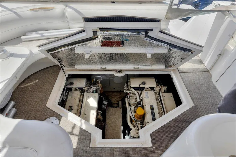 Slide: The Image of 1999 Cruisers Yachts 3870 Esprit engine compartment with open hatch, showcasing dual engines. - 27