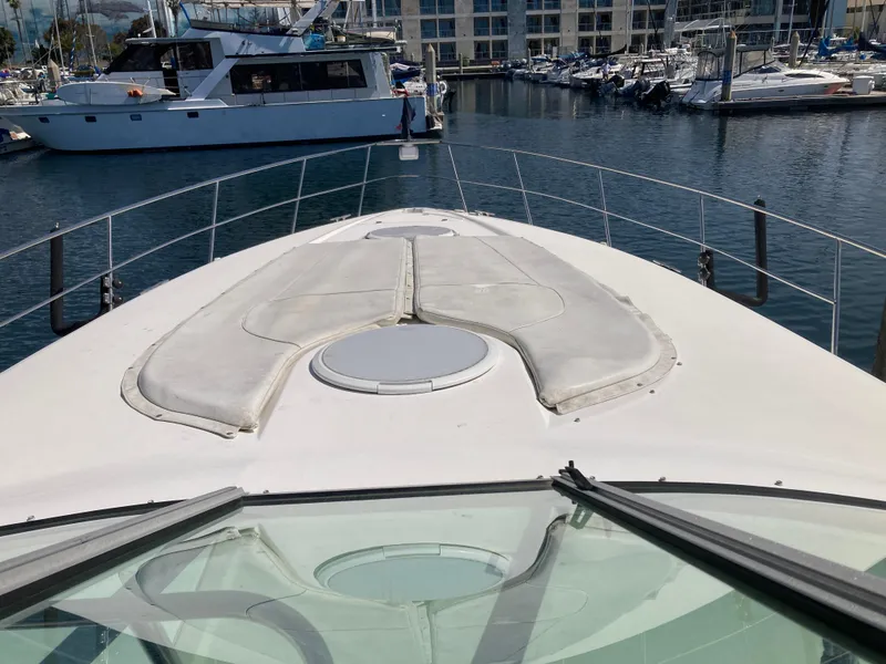 Slide: The Image of 1999 Cruisers Yachts 3870 Esprit on water, marina background, view from bow. - 10