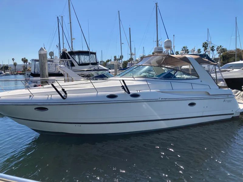 Slide: The Image of 1999 Cruisers Yachts 3870 Esprit docked in a marina under clear blue skies. - 2