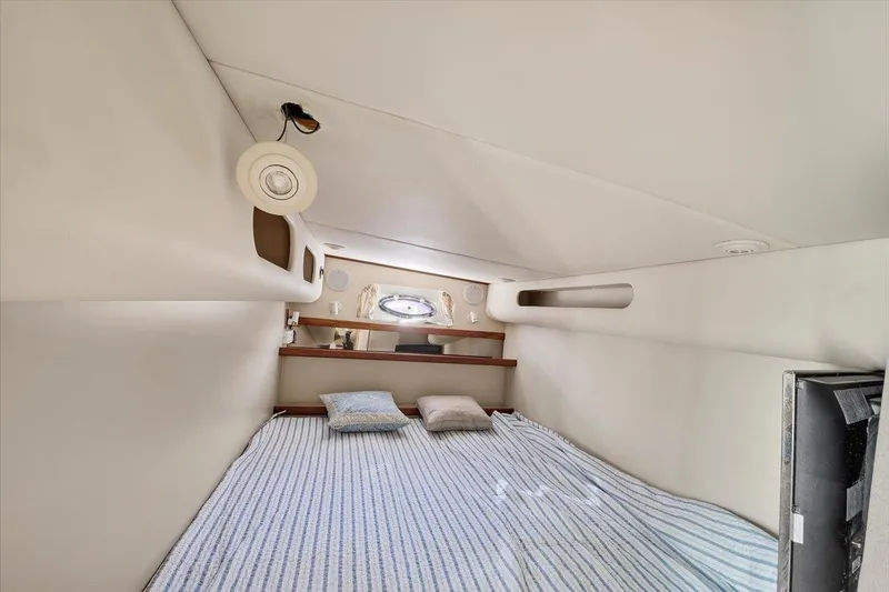 Slide: The Image of 1999 Cruisers Yachts 3870 Esprit cabin interior with bed and porthole window. - 24