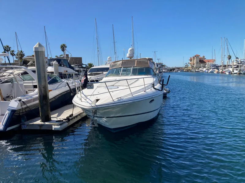 Slide: The Image of 1999 Cruisers Yachts 3870 Esprit docked in a sunny marina. - 4