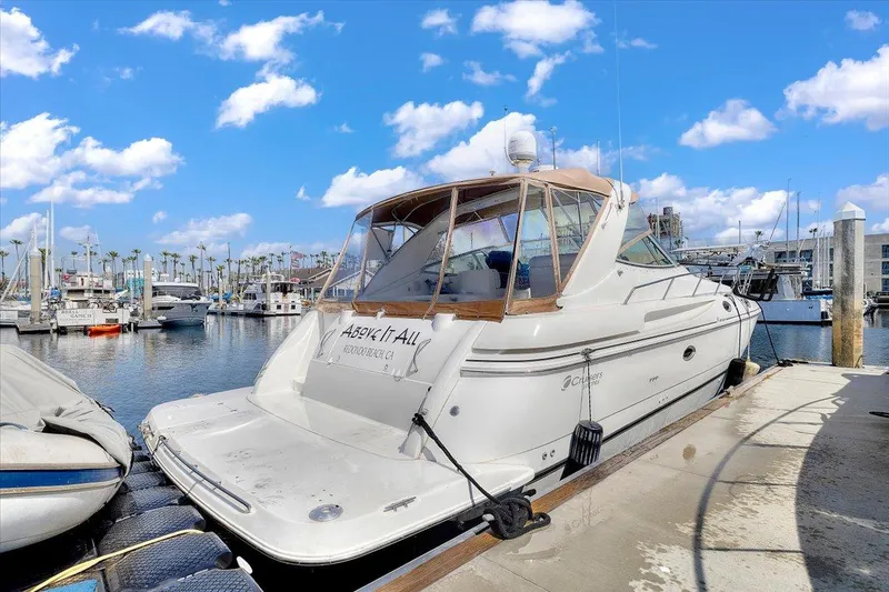 Slide: The Image of 1999 Cruisers Yachts 3870 Esprit docked at marina under blue sky. - 7