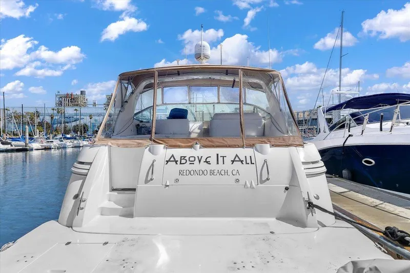 Slide: The Image of 1999 Cruisers Yachts 3870 Esprit docked at marina, clear sky background. - 8