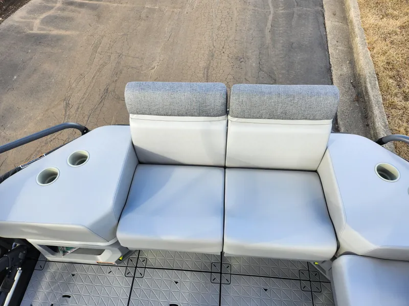 Slide: The Image of 2022 Sea-Doo Switch Cruise 21 seating area with cup holders, gray upholstery. - 14