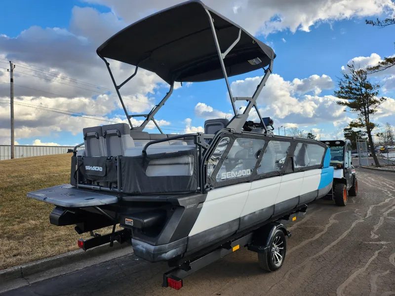 Slide: The Image of 2022 Sea-Doo Switch Cruise 21 pontoon boat on trailer under cloudy sky. - 3