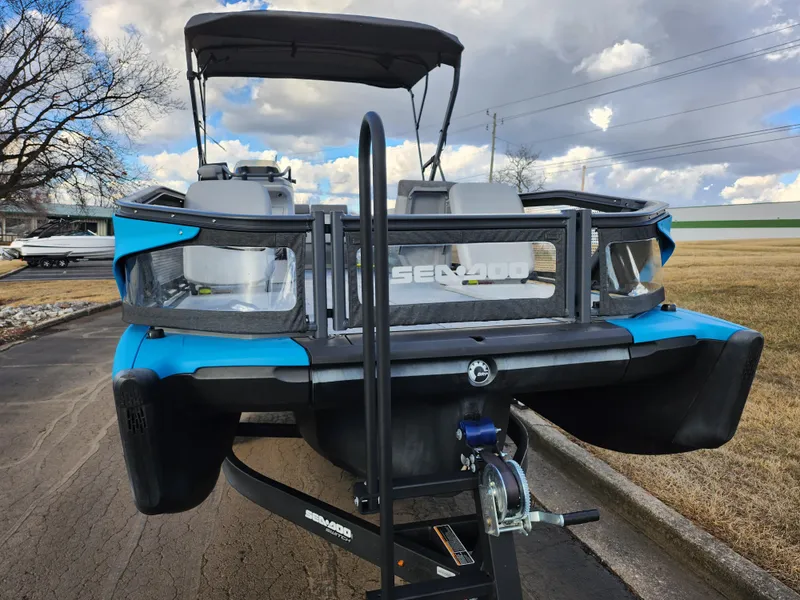 Slide: The Image of 2022 Sea-Doo Switch Cruise 21 on trailer, blue and black design, parked outdoors. - 6