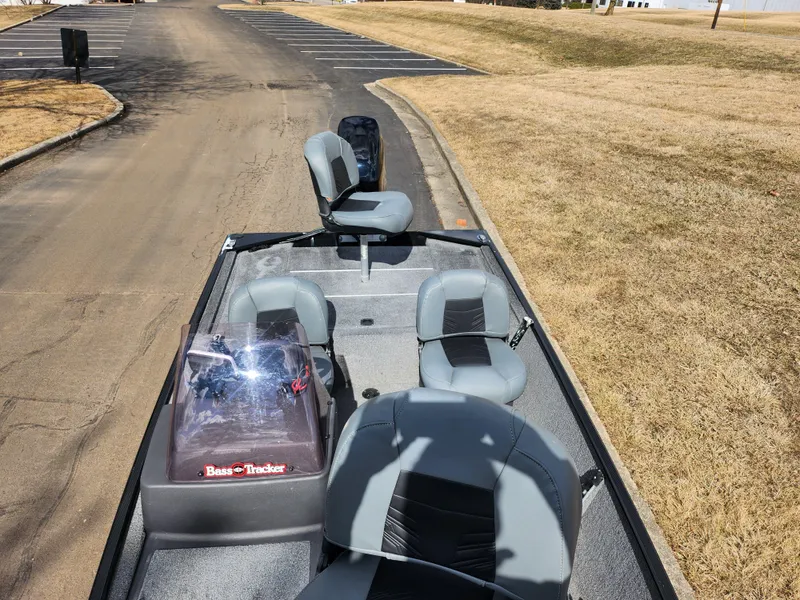 Slide: The Image of 2021 Tracker Bass Tracker Classic XL boat with gray seating on a paved road. - 17