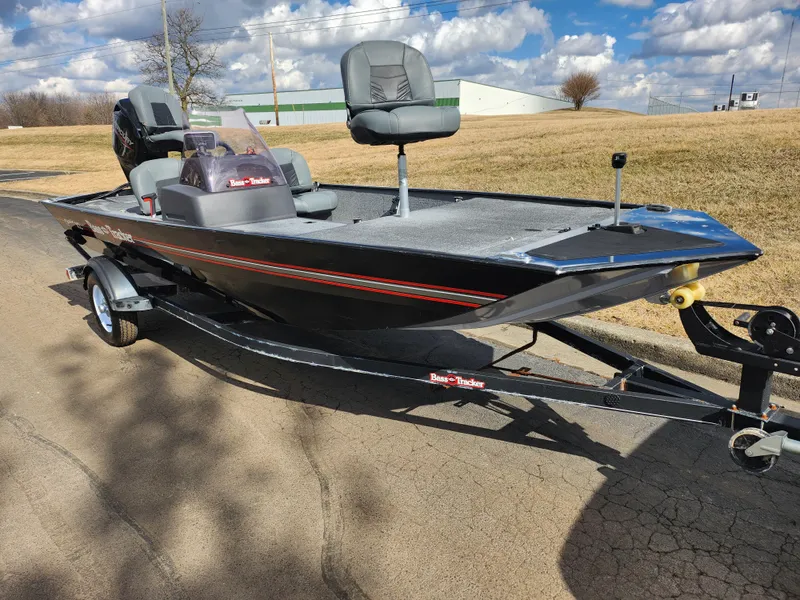 Slide: The Image of 2021 Tracker Bass Tracker Classic XL boat on trailer, parked outdoors under a cloudy sky. - 5