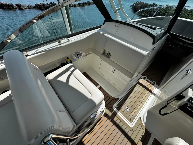 Slide: The Image of 2019 Boston Whaler 270 Vantage interior with sleek seating and wood flooring. - 21
