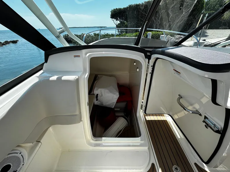 Slide: The Image of 2019 Boston Whaler 270 Vantage interior storage compartment with scenic ocean view. - 26