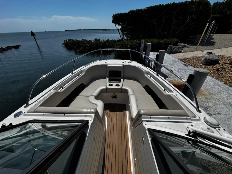 Slide: The Image of 2019 Boston Whaler 270 Vantage boat docked by serene waterfront. - 27