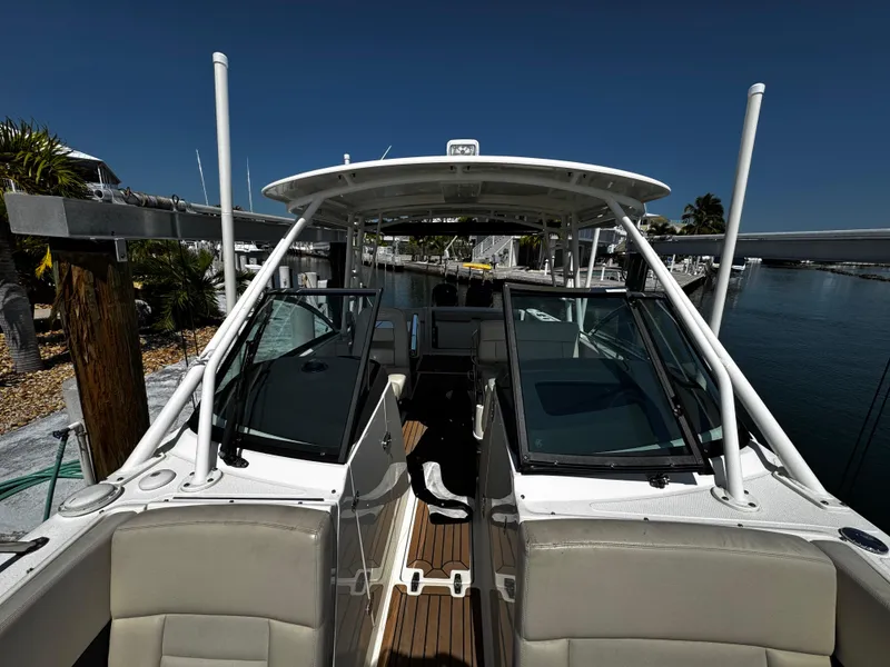 Slide: The Image of 2019 Boston Whaler 270 Vantage boat docked, featuring spacious seating and sleek design. - 31
