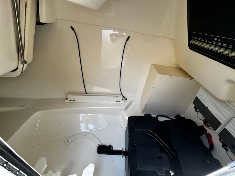 Slide: The Image of 2019 Boston Whaler 270 Vantage interior cabin with storage and control panel. - 40