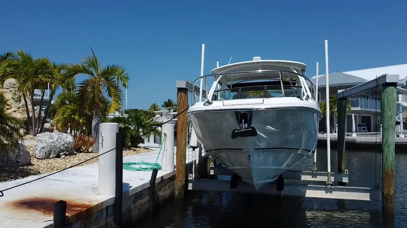 Slide: The Image of 2019 Boston Whaler 270 Vantage docked at marina with palm trees. - 7