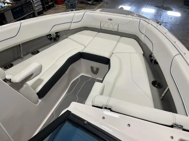 Slide: The Image of 2020 Regal LS6 Surf boat interior with white cushioned seating and cup holders. - 12