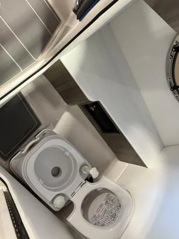 Slide: The Image of 2020 Regal LS6 Surf boat interior with compact toilet and modern design. - 14