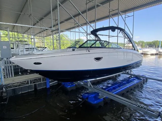 Slide: The Image of 2020 Regal LS6 Surf boat on lift in marina setting. - 3