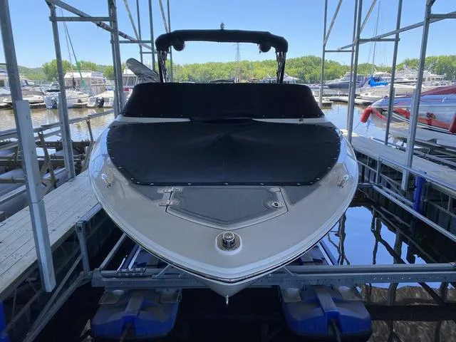 Slide: The Image of 2020 Regal LS6 Surf boat docked, covered, and ready for water adventures. - 4