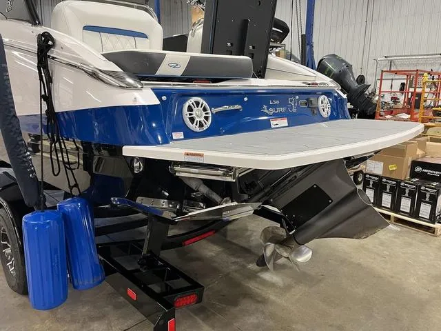 Slide: The Image of 2020 Regal LS6 Surf boat in a warehouse, showcasing rear design and propeller. - 5
