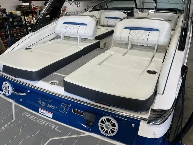 Slide: The Image of 2020 Regal LS6 Surf boat with luxurious seating and modern design in a showroom. - 6