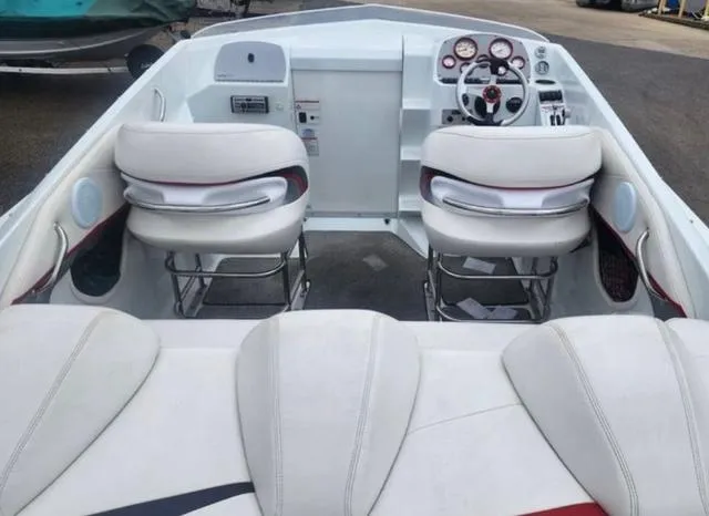 Slide: The Image of 2006 Baja 23 Outlaw boat interior with white seating and dashboard controls. - 4
