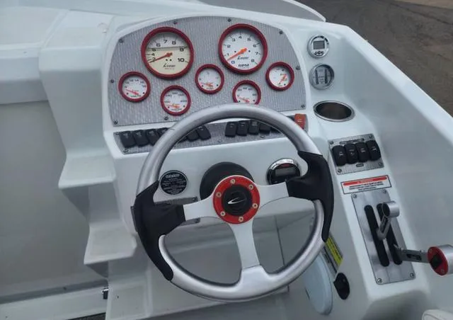 Slide: The Image of 2006 Baja 23 Outlaw boat dashboard with steering wheel and gauges. - 5