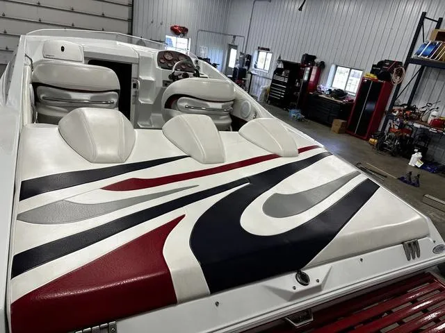 Slide: The Image of 2006 Baja 23 Outlaw boat interior with stylish upholstery in a garage setting. - 6