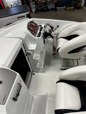 Slide: The Image of 2006 Baja 23 Outlaw boat interior with white seating and control panel. - 7