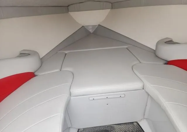 Slide: The Image of Interior of a 2006 Baja 23 Outlaw boat with white and red seating. - 8