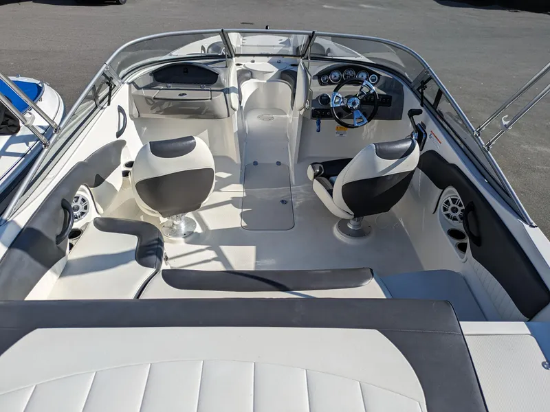Slide: The Image of 2018 Stingray 208 LS boat interior with dual seats and steering console. - 10